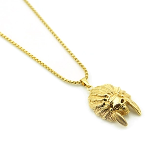 Macro detail of golden Indian skull pendant with feather crown on box chain necklace