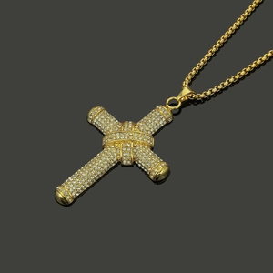 Gold hip hop cross pendant necklace with sparkling pavé crystals and box chain on mirror