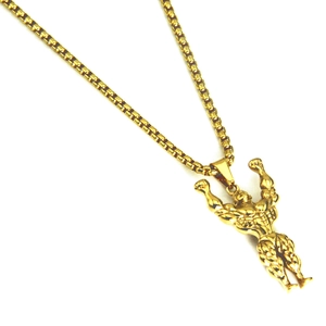Detailed view of a gold-plated muscular bodybuilder pendant on a box chain necklace