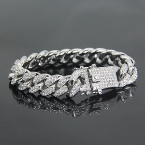 Macro shot of 12mm iced out silver Cuban link bracelet with clear rhinestones