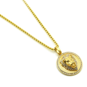 Close-up of gold lion head pendant with micro-paved white zircons on a round box chain