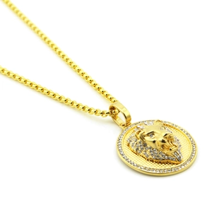 Macro view of gold lion head pendant with sparkling rhinestones on box chain