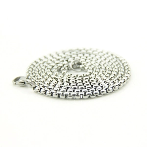 Detailed view of silver box chain necklace with secure lobster clasp closure on white