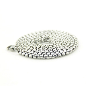 Detailed view of silver box chain necklace featuring a secure lobster claw clasp