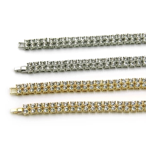 Detailed view of silver and gold double-row rhinestone chains with secure fold-over clasps