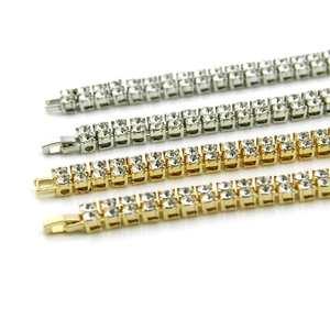 Close-up of double row iced out hip hop tennis bracelets in gold and silver finishes