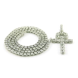 Macro detail of silver iced out Ankh cross pendant with sparkling tennis chain
