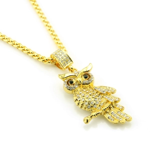 Détail du pendentif hibou hip hop avec cristaux étincelants et chaîne dorée maillée