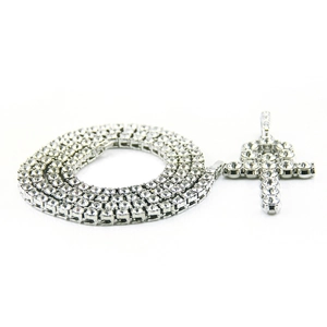 Close-up of silver tennis chain and iced out Ankh cross pendant with zircons