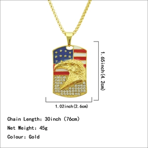 Gold American flag dog tag necklace featuring a bold eagle head and sparkling crystals