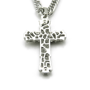 Detailed view of silver cross pendant with hollow mesh design and polished cuban chain