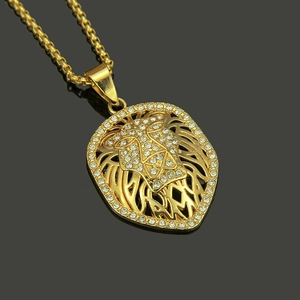 Iced out gold lion head pendant necklace with rhinestones on dark reflective background