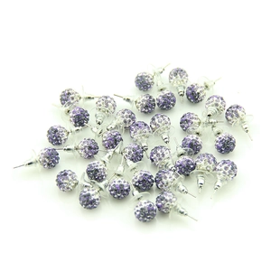 Close-up of sparkling purple and clear crystal ball stud earrings with plastic backings