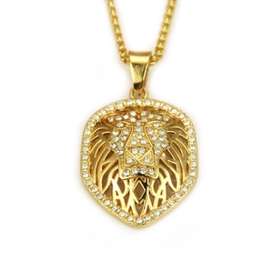 Detailed close-up of hip hop golden lion pendant with sparkling rhinestones and box chain