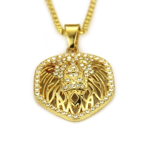 Hip hop style gold lion head pendant necklace with sparkling white rhinestones on white background