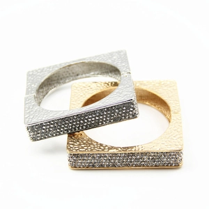 Detail of square alloy bangles with hammered texture and pave set rhinestones