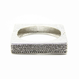 Macro shot of silver square bracelet featuring micro-pave diamonds and hammered texture