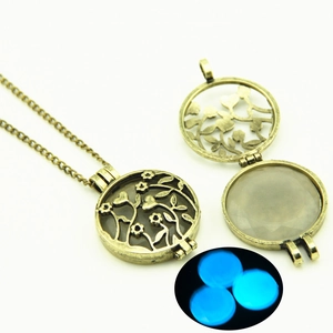 Antique bronze hollow tree pendant necklace with glowing blue bead in the dark