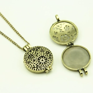 Detailed view of steampunk hollow gear pendant showing the open and closed locket structure