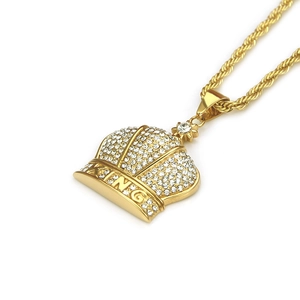 Detailed view of the gold KING crown pendant with shimmering crystals on a twist chain