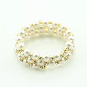 Three-layer wrap bracelet featuring white pearls, gold spacers, and sparkling rhinestones