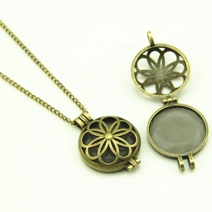 Detailed view of bronze hollow luminous locket necklace showing open and closed states