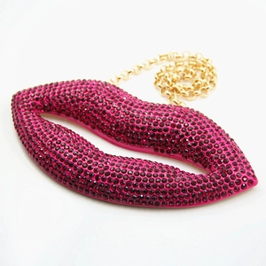 Red lip-shaped evening clutch bag with sparkling rhinestones and gold chain strap