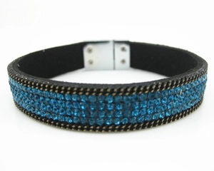 Close-up of sky blue 4-row rhinestones on black velvet bracelet with magnetic clasp