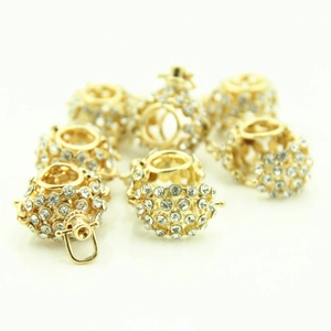 Close-up of sparkling hollow alloy sphere pendants with pavé rhinestones for DIY jewelry