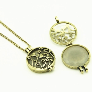 Vintage hollow glowing locket necklace with tree pattern and faceted stone insert