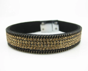Detail of amber rhinestone crystals on black velvet bracelet with silver magnetic clasp
