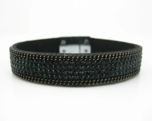 Detail showing four rows of dark green rhinestones on black velvet magnetic bracelet