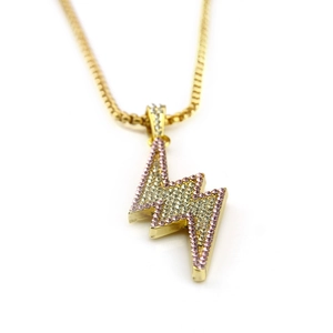 Detailed close-up of hip hop lightning pendant with gold plating and white crystals