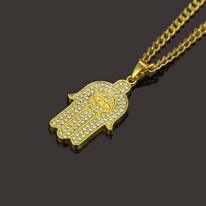 Gold Hamsa Hand pendant necklace for men with cubic zirconia stones and evil eye detail