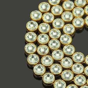 Macro detail of high-quality gold plating and dense pavé rhinestones on hip hop chain