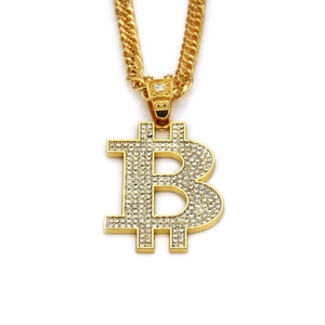Close-up of hip hop gold Bitcoin pendant necklace with sparkling diamonds and cuban chain