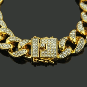 Men's hip hop gold Cuban link bracelet with iced out diamond square clasp on black reflective base