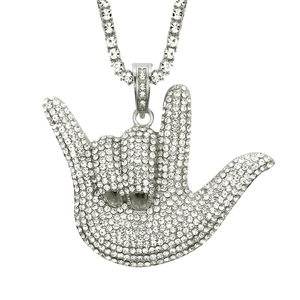 Macro shot of hip hop pendant featuring iced out hand gesture with sparkling diamonds
