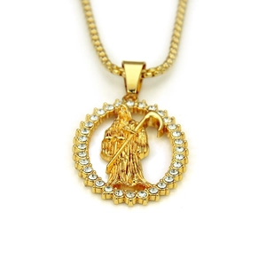 Close-up of golden Santa Muerte pendant with sparkling cubic zirconia on a thick link chain