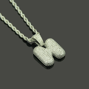 Macro shot of large letter H pendant with micro-paved white zircons on rope chain