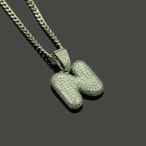 Macro shot of silver hip-hop bubble letter H pendant with micro-pave cubic zirconia