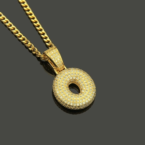 Macro view of gold-plated Hip Hop necklace with micro-pave cubic zirconia letter pendant