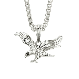 Detailed view of hip hop eagle pendant necklace with sparkling crystal inlay on white