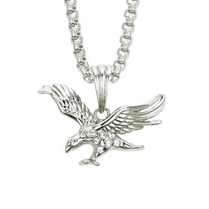 Macro shot of a silver eagle pendant with sparkling crystal inlay on a sturdy link chain