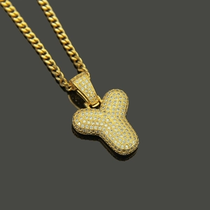 Macro detail of iced-out bubble letter Y pendant with cubic zirconia and cuban chain