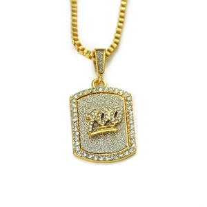 Detailed close-up of gold hiphop pendant with 100 emoji design and iced-out rhinestones