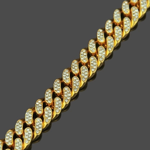 Hip hop style gold Cuban link bracelet with iced-out pave set rhinestones on a reflective base