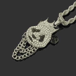 Close-up of hip hop skull pendant with crown and handset white and black stones
