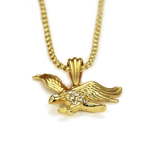 Macro view of gold eagle pendant with seven inlaid crystals and sturdy box chain link