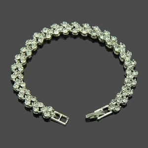 Detail view of a silver Roman bracelet with triple rows of crystals and fold-over clasp